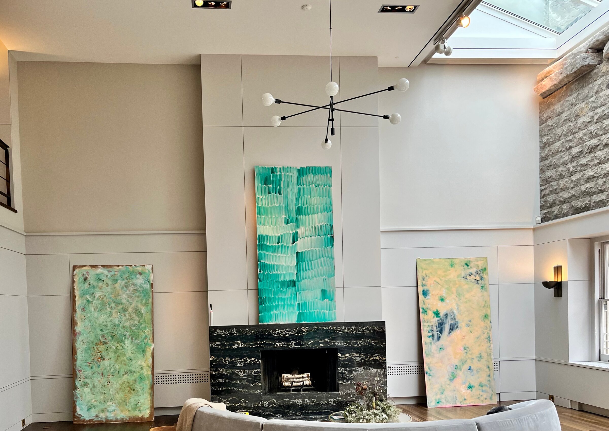 Three of Emily's paintings in a living room